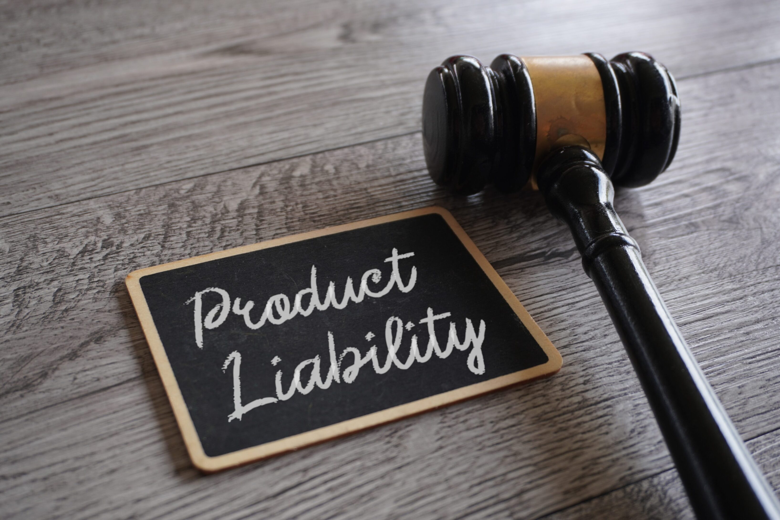 Closeup image of judge gavel and text PRODUCT LIABILITY Closeup image of judge gavel and text PRODUCT LIABILITY on table.